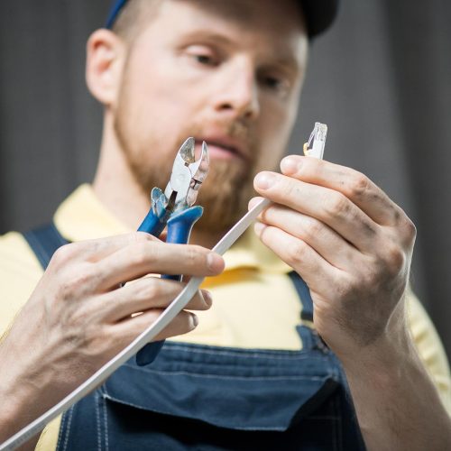 man-checking-power-cable-CNDU3R7.jpg